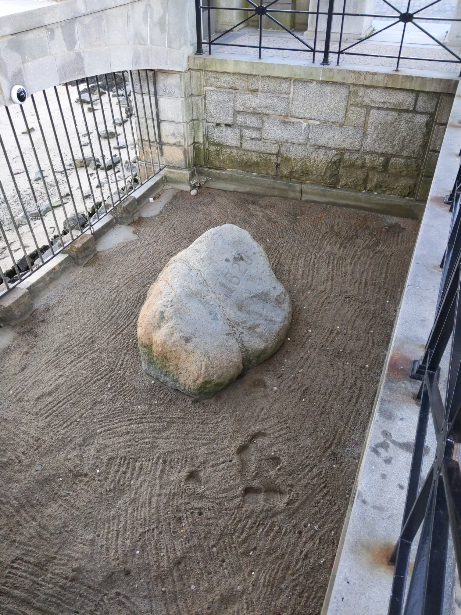 Here is Plymouth Rock, the rock marked by the pilgrims when they traveled to America on the Mayflower. It seems to be marked with the year '1620'.